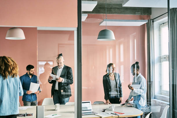 istock Diverse group of business people having meeting inside office boardroom 2185972113