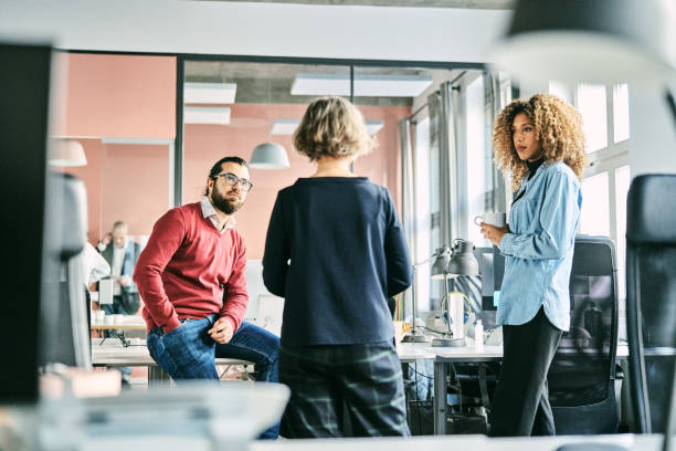 Diverse business team having discussion during break at office