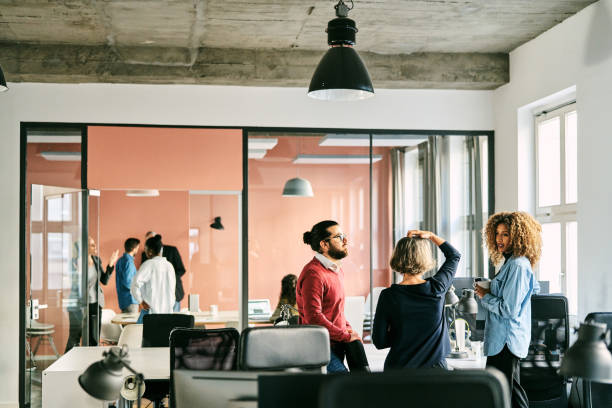 istock Business colleagues having casual discussion during work break in office 2185972203