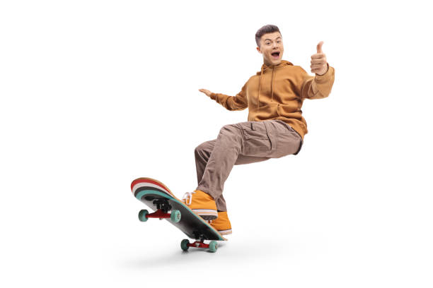 istock Excited young man riding a longboard and gesturing thumbs up 2185976792
