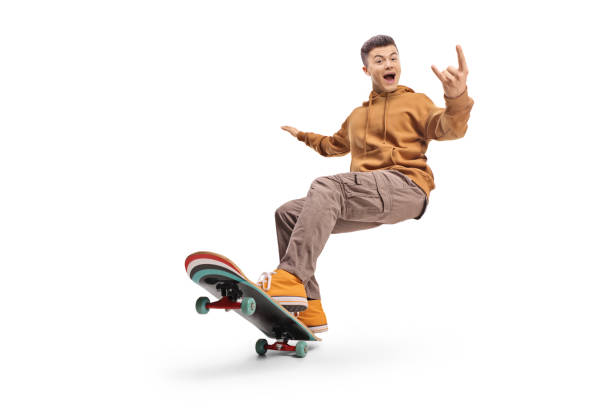 istock Excited young man riding a longboard and gesturing rock and roll sign 2185977475