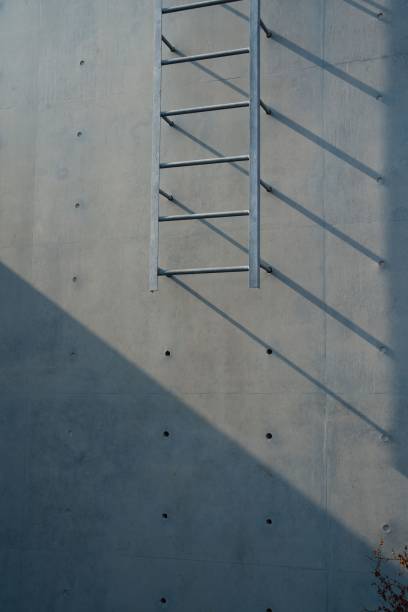 istock Metal ladder shadow on concrete wall 2185978437