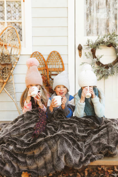 istock Children on a Charming Rustic Porch with Hot Chocolate 2185978833