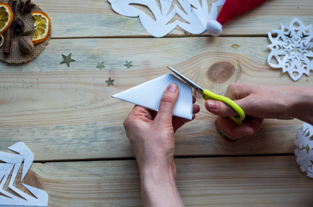 istock A snowflake made from paper with your own hands gracefully decorates a winter interior, adding warmth and a cozy atmosphere 2185979621