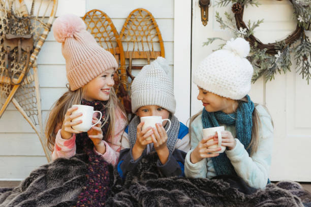 istock Children on a Charming Rustic Porch with Hot Chocolate 2185979626