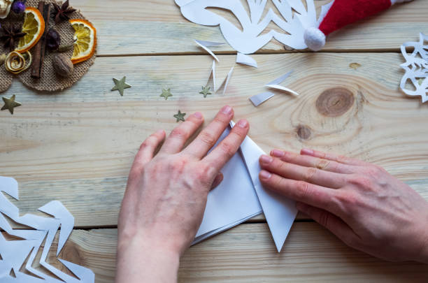 istock A snowflake made from paper with your own hands gracefully decorates a winter interior, adding warmth and a cozy atmosphere 2185979768