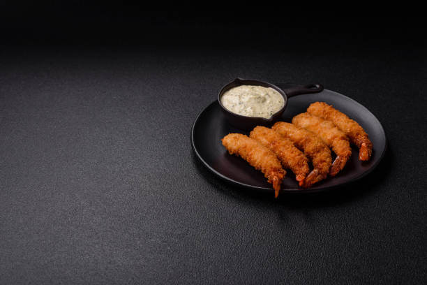 istock Hot crispy shrimp breaded with salt and spices with white sauce 2185980466