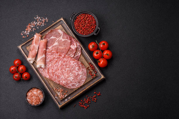 istock Antipasto jamon, prosciutto, sausage, sliced with tomatoes, salt and spices 2185980997