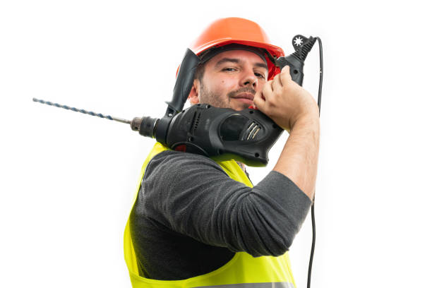 Construction worker using a cordless drill to work on a construction site