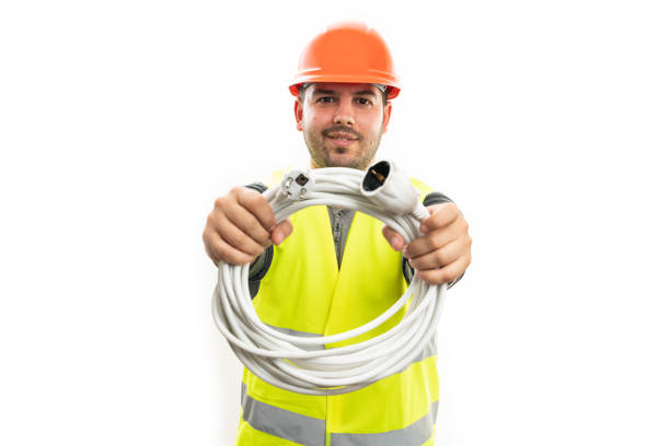 istock Friendly trades workman holding extension lead or cable 2185982968