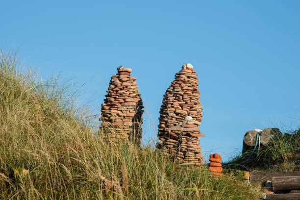 istock Twin Stacked Pebble Towers in Grassland 2185985075