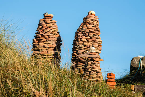 Stacked Stone Towers on Grassy Hill