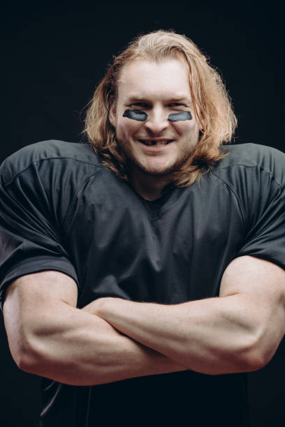 istock Determined American football player posing with painted face and chewing gum 2185985761