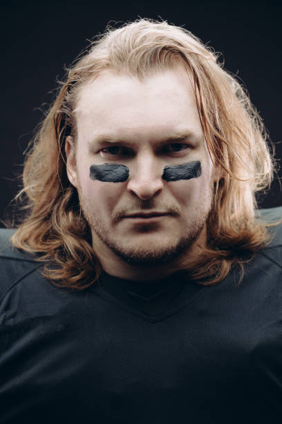istock Determined American football player posing with painted face and chewing gum 2185985765
