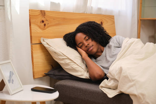 istock Serene young woman sleeping peacefully in bed: embracing rest and tranquility 2185986639