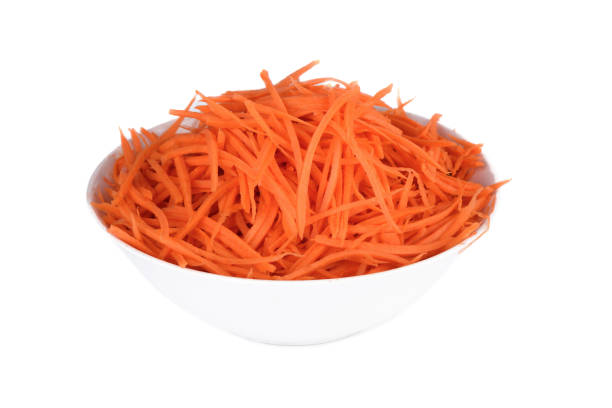 istock Sliced ​​carrots in a white bowl over white background. 2185989439
