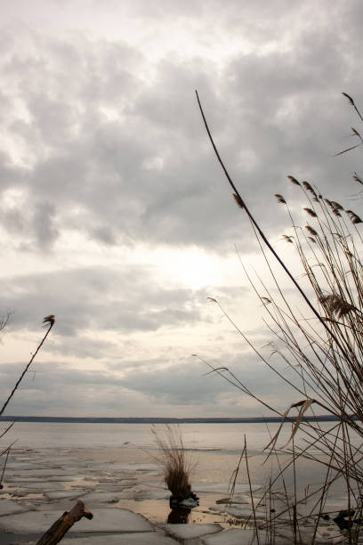istock a lake with ice and a cloudy sky in the background 2185989740