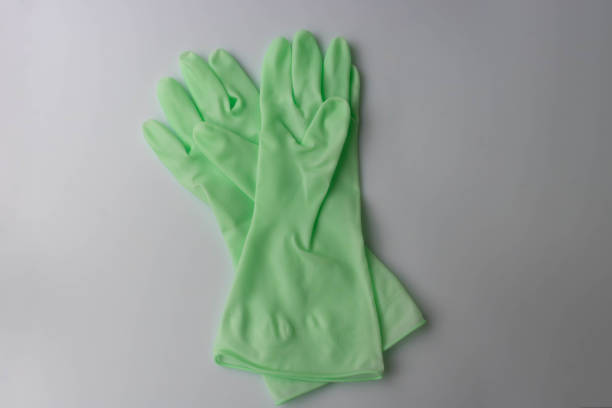 istock Two light green rubber gloves are lying on the table. 2185990608