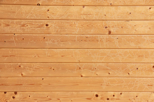 Brown wood texture with white frost patterns. Winter background.