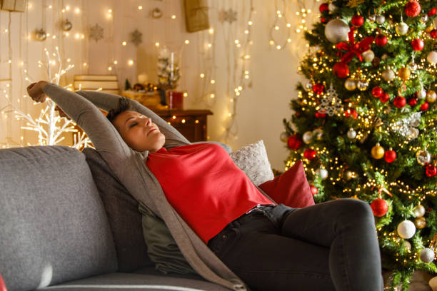 istock Relaxing at Home Next to a Beautifully Decorated Christmas Tree 2185993529