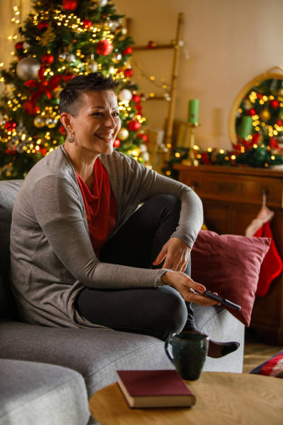 istock Smiling woman uses mobile phone 2185993697