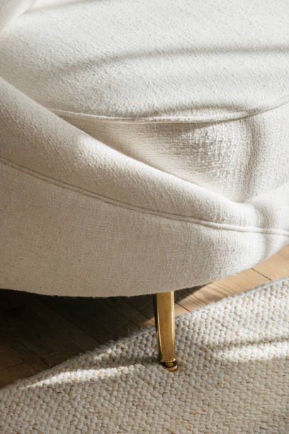 Elegant upholstered sofa with golden legs in a modern living room setting