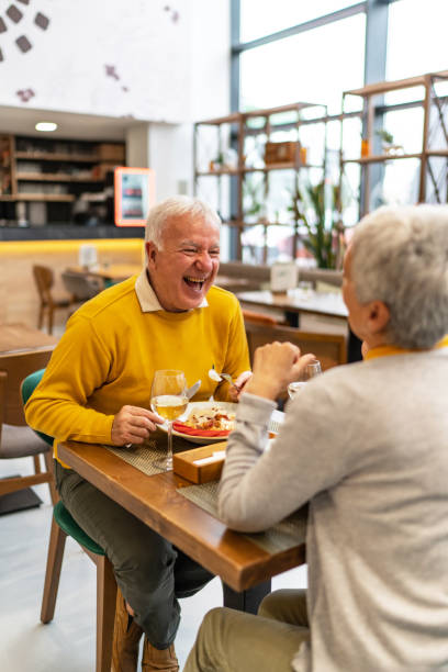 istock Cheerful senior people eating in the restaurant 2185996648