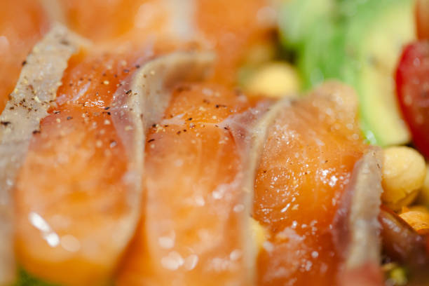 Close-up of various home-cooked dishes served on a dining table during Chinese New Year's Eve family reunion dinner. The spread includes curry chicken, stir-fried mixed vegetables, sweet and sour fish, pork roll and white pepper pork intestine soup.