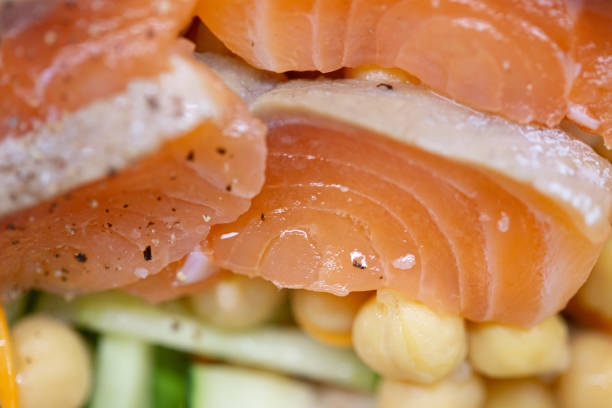 Wild Sockeye Salmon fillet on bamboo with lemons and dill herb