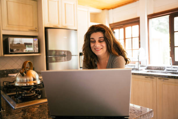 istock Woman using laptop in cozy home, relaxed 2186014681