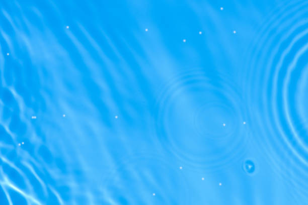 istock Blue water with ripples on the surface. Defocus blurred transparent blue colored clear calm water surface texture with splashes and bubbles. Water waves with shining pattern texture background. 2186015123