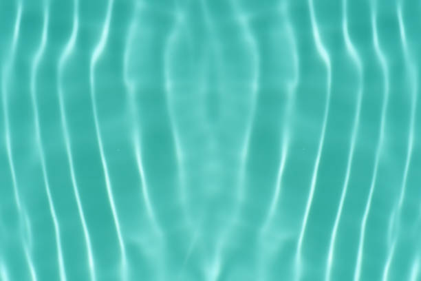 Multicolored reflections and highlights on the surface of sea water in sunny day. Vertical abstract wallpaper or background