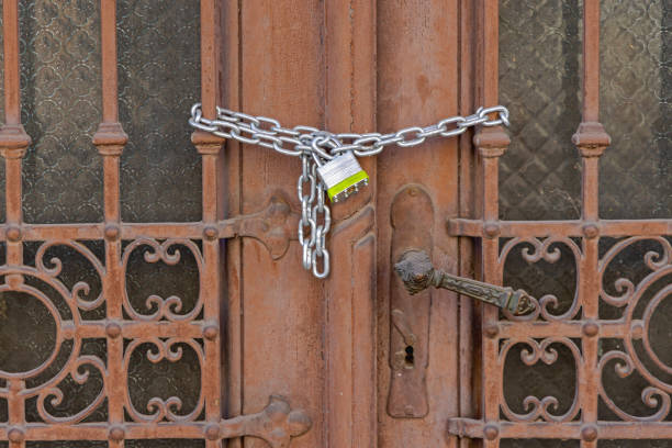 Strong Steel Padlock With Chain at Old Door Building Security