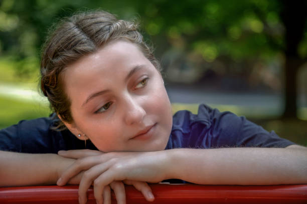 istock Thoughtful Young Woman Relaxing Outdoors in Natural Light 2186017174