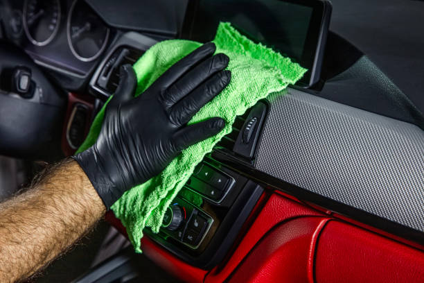istock Hand cleaning the car interior with green microfiber cloth. Hand with microfiber cloth cleaning leather seat,auto detailing and valeting concept,washing car care interior. 2186018277