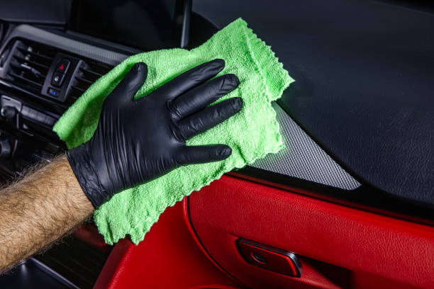 istock Hand cleaning the car interior with green microfiber cloth. Hand with microfiber cloth cleaning leather seat,auto detailing and valeting concept,washing car care interior. 2186018763