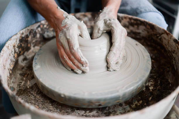 istock Art clay, Close up Hands work on ceramic wheel at pottery workshop. Small business and handmade crafts 2186020379