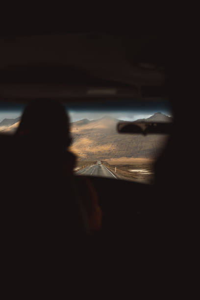 istock Driving towards the mountains on a long empty road in iceland 2186021338