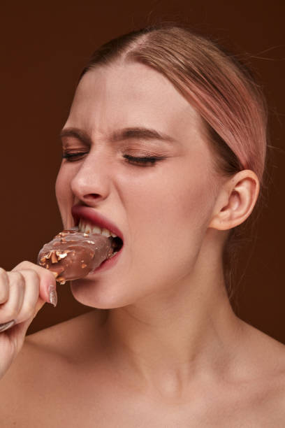 istock Beautiful young woman eating ice cream. 2186022192