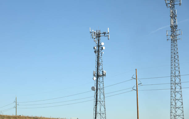Repeater towers and utility poles line Stoney Trail or Highway 201 in Calgary.
