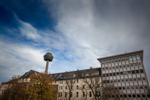 PIcture of the Colonius tower in Cologne. Colonius is the Cologne telecommunications tower, which was finished in 1981. The Colonius possesses a cafeteria, viewing platform, and a restaurant, apart from antennas for radio relay and radio services within the VHF range. Because of a missing leaseholder, the visitor's area including restaurant and viewing platform has been closed since 1992. The photograph captures a dramatic upward perspective of the Colonius Tower, located in the Ehrenfeld district of Cologne, Germany. The tower dominates the skyline, emphasizing its substantial height and modern architectural design against the backdrop of the sky. As a key telecommunications tower, Colonius serves as both a functional structure for broadcasting and a prominent city landmark. The angle of the shot from below accentuates its towering presence and the engineering prowess involved in its construction. The surrounding Ehrenfeld district is known for its vibrant culture and urban development. This image encapsulates themes of modern engineering, urban architecture, technological infrastructure, and Cologne's cityscape, making it pertinent for discussions on telecommunications, architecture, and German landmarks.