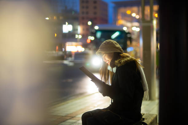 istock Young Asian woman using digital tablet in the city. 2186026353