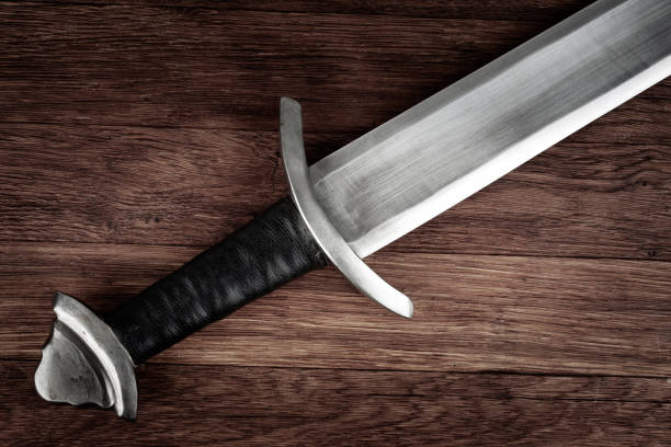 istock Medieval sword on wooden background. 2186032558