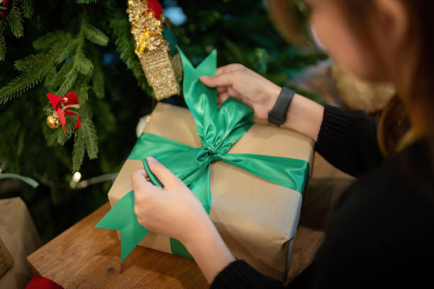 istock Holiday Enthusiast Completing Gift Wrapping with Festive Flair 2186036017