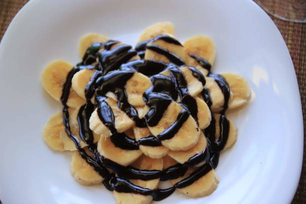 istock African Dessert: Sliced Bananas Drizzled with Rich Chocolate Sauce 2186047255