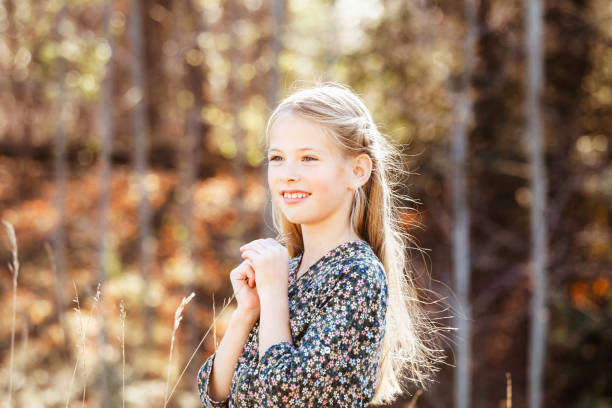 A beautiful, eight-year-old girl enjoying nature in the fall. Shot with a Canon 5D Mark IV.