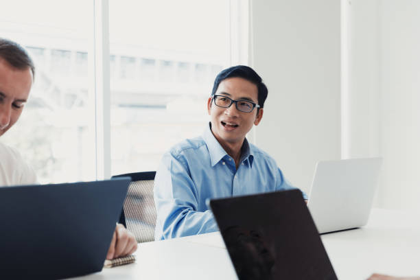 istock Team members engage in a productive meeting discussing project updates in a bright, modern office space 2186054826