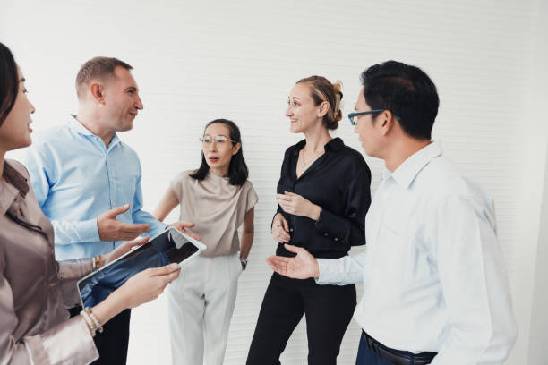 istock Group of professionals engaged in discussion during a team meeting at a modern office environment 2186062214