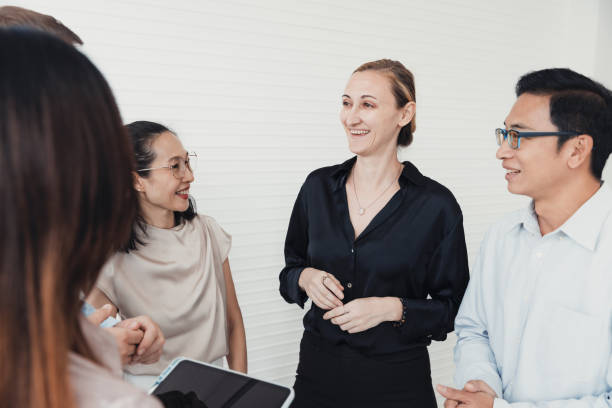 istock Group of professionals engaged in lively discussion in a modern office setting during a daytime meeting with diverse team interaction 2186062241