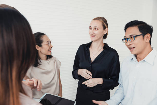 istock Business professionals engage in discussion during a team meeting in a bright office environment 2186062250